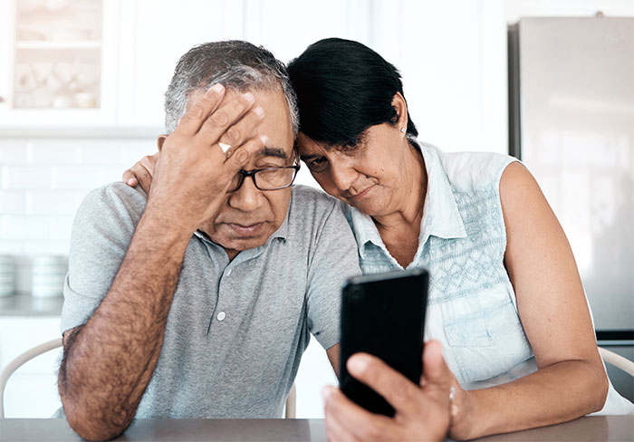A woman is told to leave home after refusing to follow one rule. Two distraught adults look at a phone.