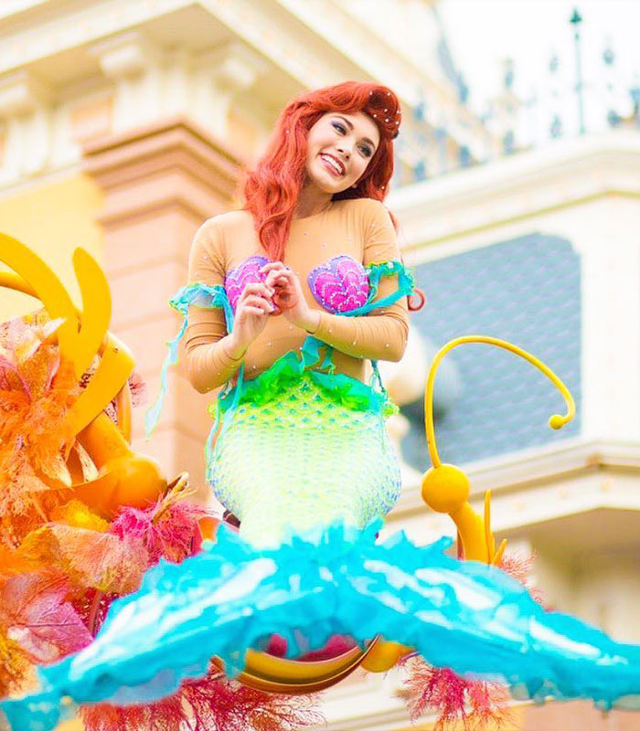 Smiling Disney princess Ariel costume at theme park parade Smiling Disney princess Ariel costume at theme park parade