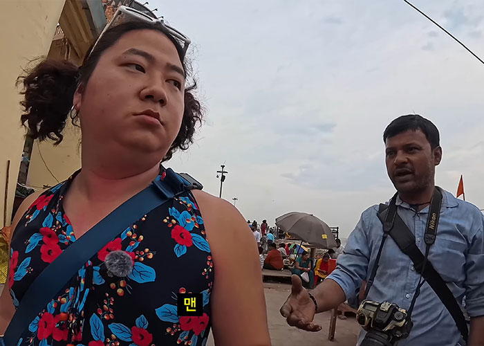 Korean man in floral dress confronted by local man showing gender violence