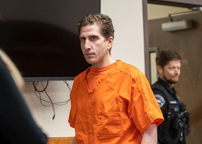 Man comforting a woman in emotional distress in court setting