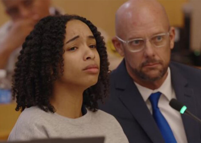 California housewife in court showing a serious expression beside her lawyer California housewife in court showing a serious expression beside her lawyer