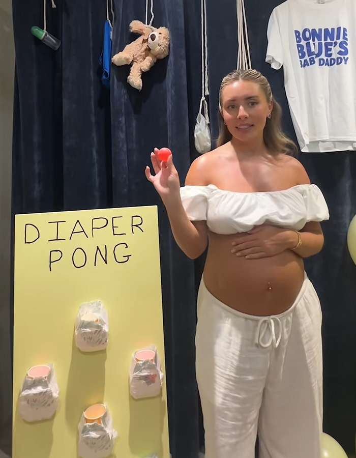 Pregnant woman playing diaper pong at Bonnie Blue's baby shower event