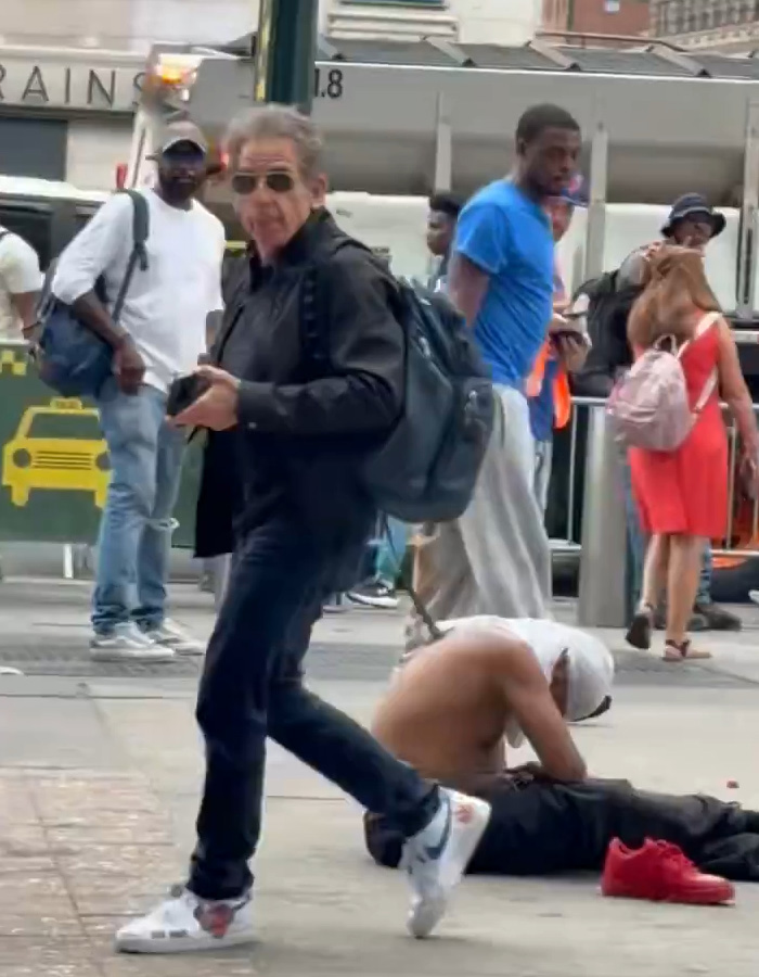 Ben Stiller walking past a homeless person sitting on the sidewalk Ben Stiller walking past a homeless person sitting on the sidewalk