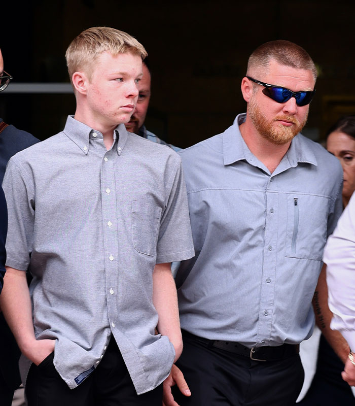 Accused teen with stepgrandma and others leaving a building Accused teen with stepgrandma and others leaving a building