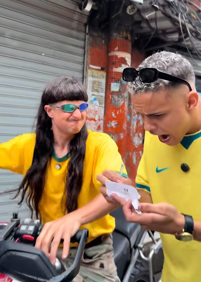 Oliver Tree and friend wearing Brazil jerseys sharing a moment in an urban Brazil setting Oliver Tree and friend wearing Brazil jerseys sharing a moment in an urban Brazil setting