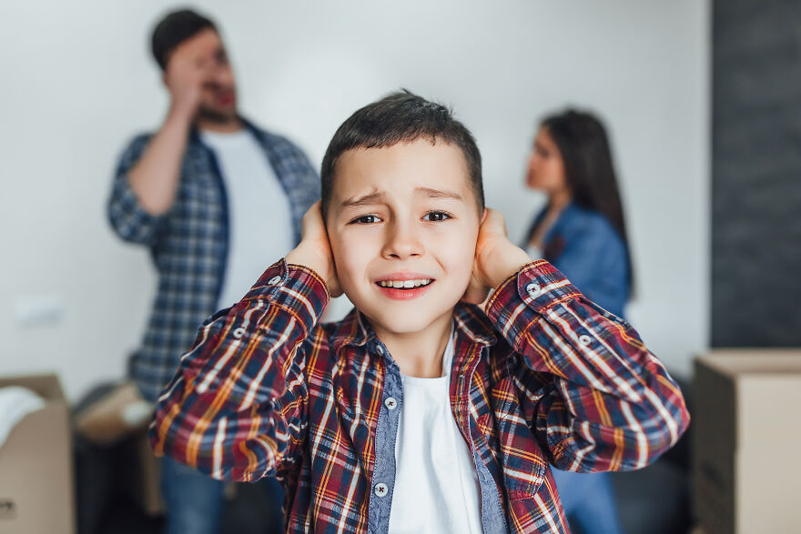 Distressed child covering ears as parents argue showing narcissistic parents impact