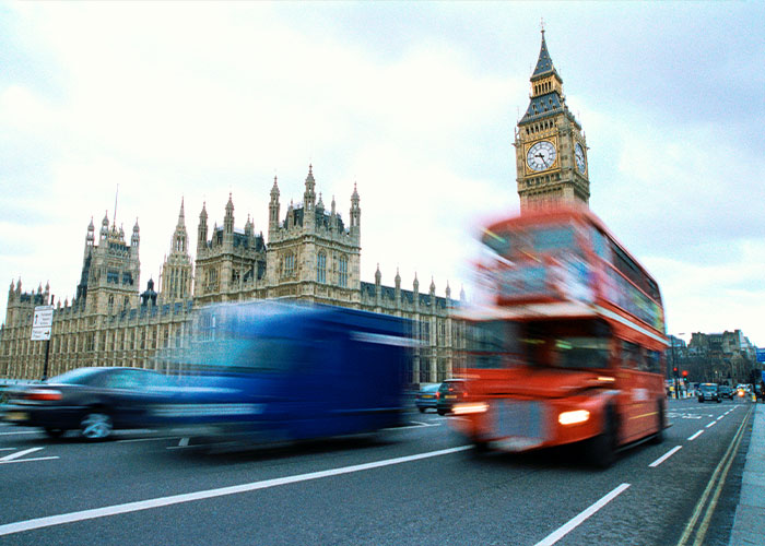 A blurry red double-decker bus and other traffic with Big Ben in the background, relating to the woman pushed in front of bus. A blurry red double-decker bus and other traffic with Big Ben in the background, relating to the woman pushed in front of bus.