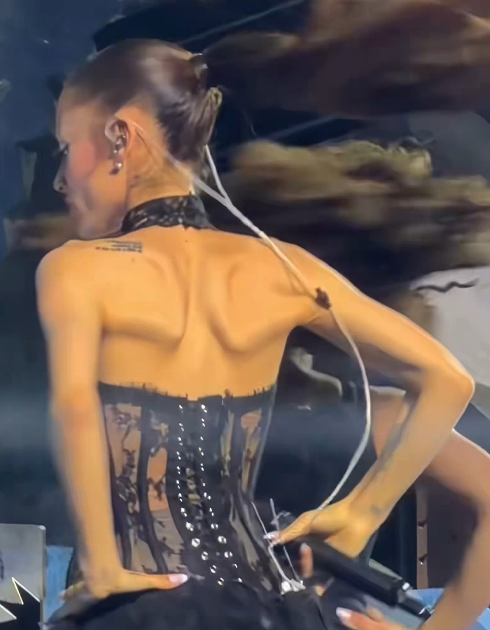 Ariana Grande's viral tour video sparks major concern among fans, showing her back and shoulders, prompting calls for help.