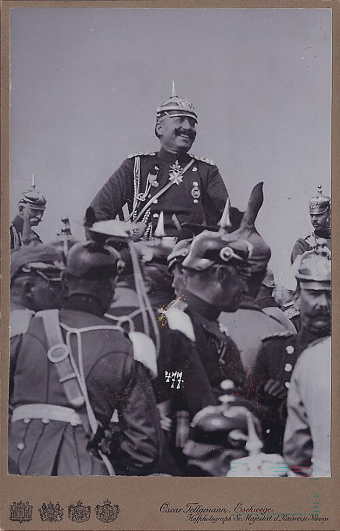 Historic photo of world leader in military uniform smiling among soldiers