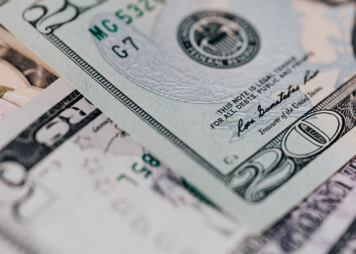 Close-up of US dollar bills representing financial mistakes