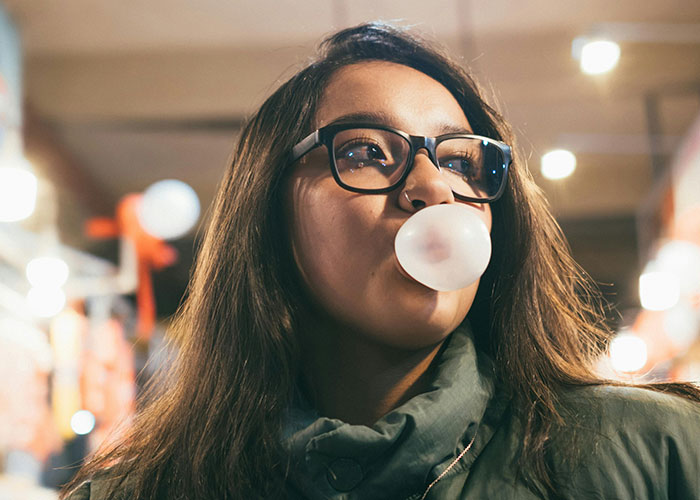Woman blowing bubblegum illustrating legal offense scenarios