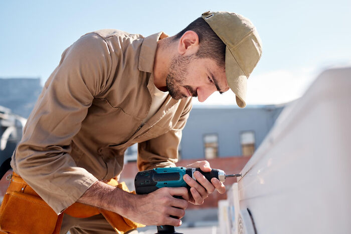 Man using drill working outside representing unsettling thing found