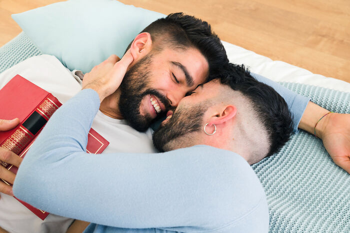 Couple sharing intimate moment holding book symbolizing scandalous family secrets