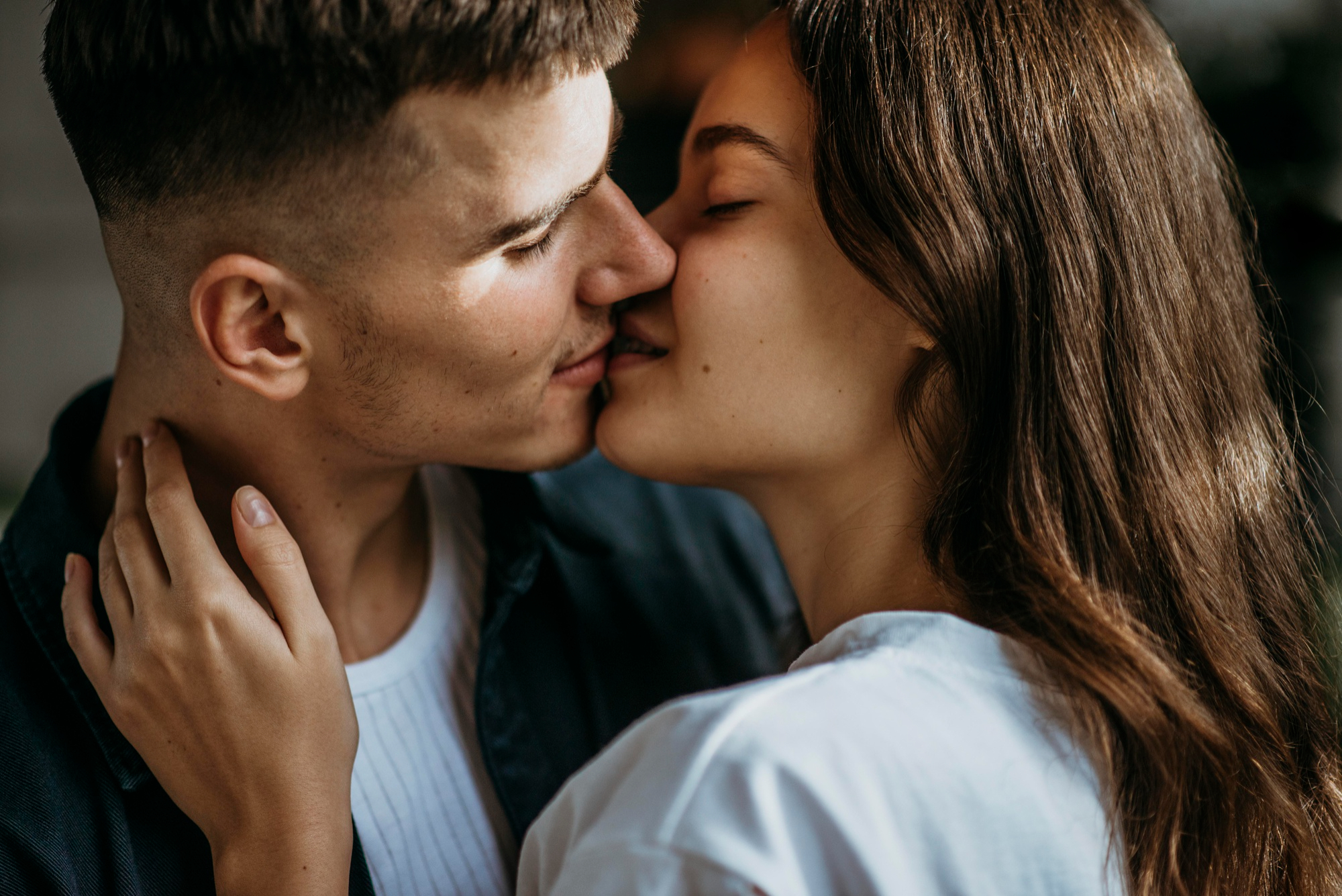 A couple sharing a tender kiss, symbolizing the start of a blind date, with a woman possibly experiencing petty payback. A couple sharing a tender kiss, symbolizing the start of a blind date, with a woman possibly experiencing petty payback.