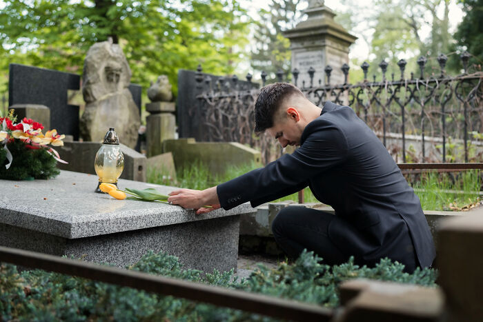Man mourning at grave representing unhinged breakup excuses