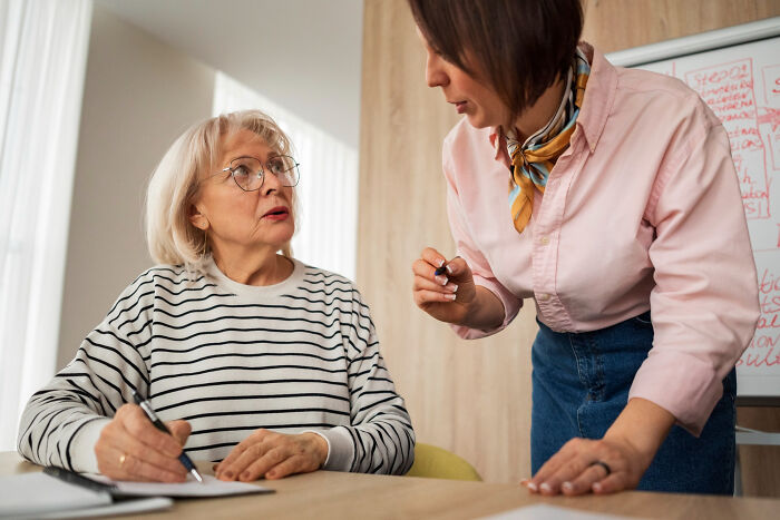 Older woman surprised by family secrets during conversation with younger woman