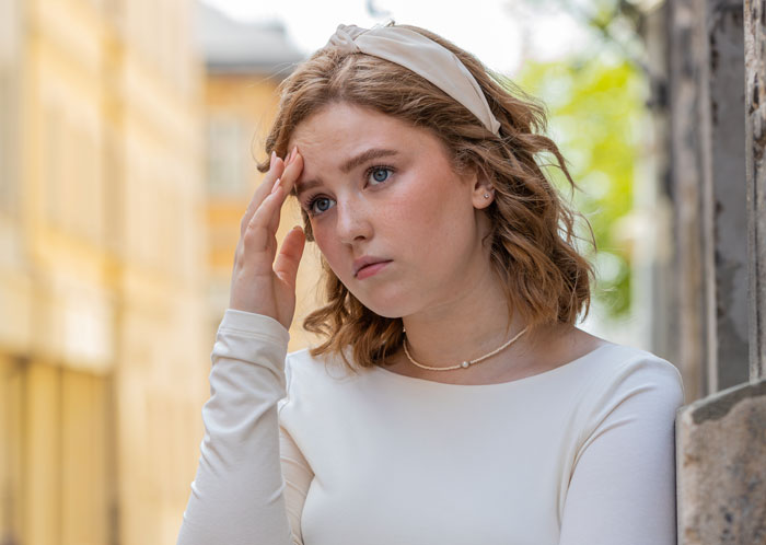 Worried woman feeling stressed outdoors relating to creepy BIL hitting on sister Worried woman feeling stressed outdoors relating to creepy BIL hitting on sister