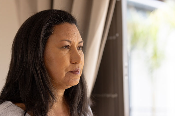A thoughtful woman considers her next steps after being told to leave home for refusing one rule.