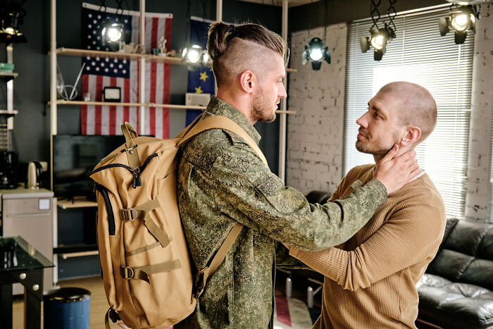 Emotional farewell between soldier and civilian indoors