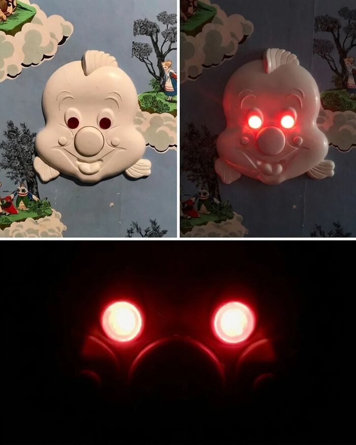 Creepy clown face light with eyes glowing red in dark