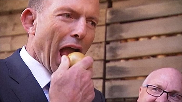 World leader taking a bite of an apple during a public event