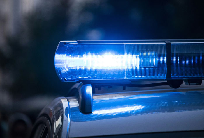 Police car with flashing blue lights responding to an entitled mom's call about trespassing. Police car with flashing blue lights responding to an entitled mom's call about trespassing.