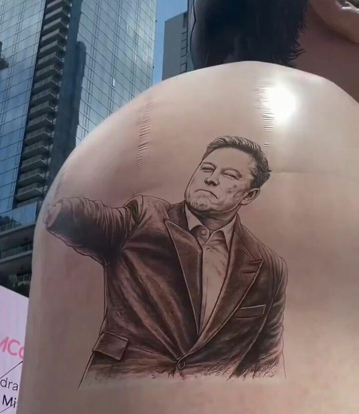 Tattoo-like image of Elon Musk on giant inflatable's back in Times Square