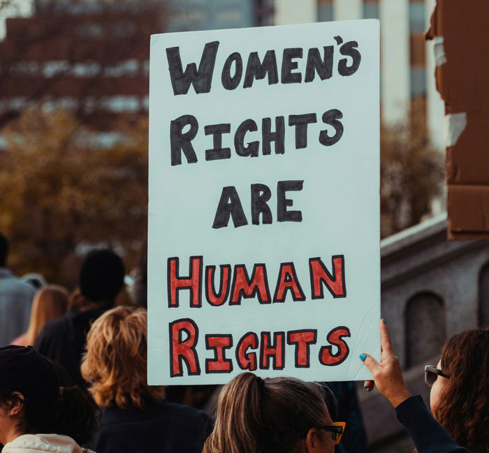Protest sign stating women's rights are human rights at a rally Protest sign stating women's rights are human rights at a rally