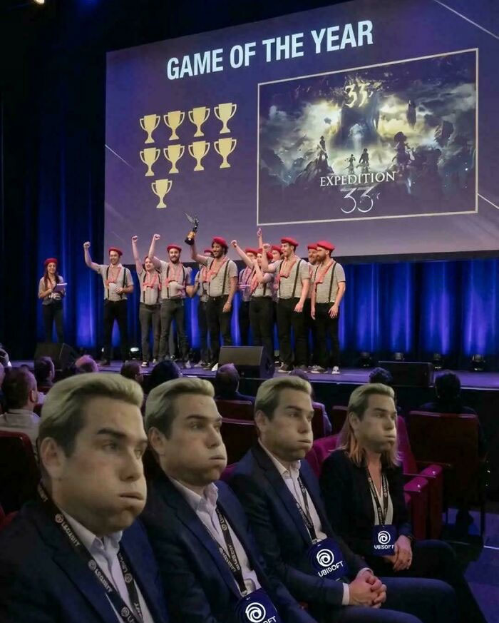 Game of the Year award ceremony with developers celebrating on stage and bored Ubisoft employees
