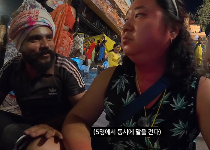 Korean man disguised as pregnant woman interacting with men on Indian street