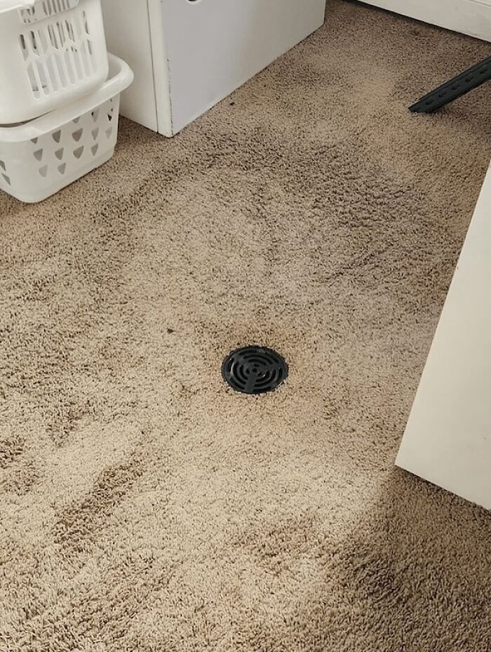 Drain installed directly in carpet showing major design fail