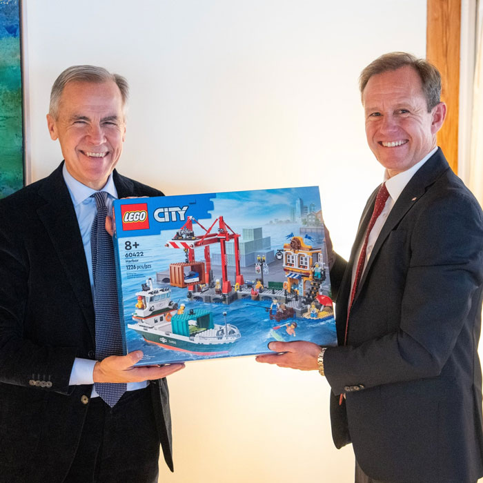 World leaders smiling while holding a LEGO City gift set