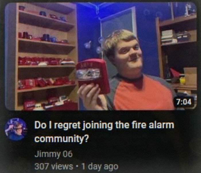 An unhinged pic from a YouTube video showing a young man with fire alarms on shelves, discussing the fire alarm community.