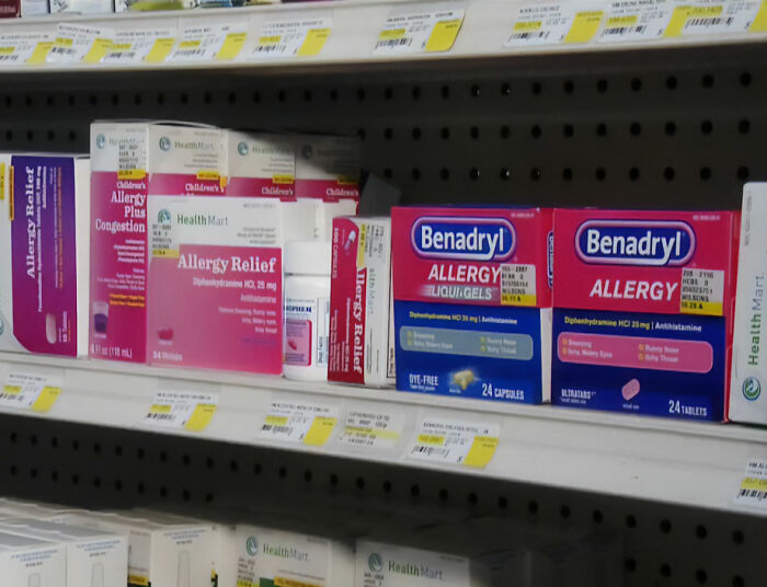 Boxes of Benadryl Allergy medication on a store shelf, linked to a dangerous social media challenge.