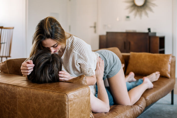 Couple romantically embracing on couch
