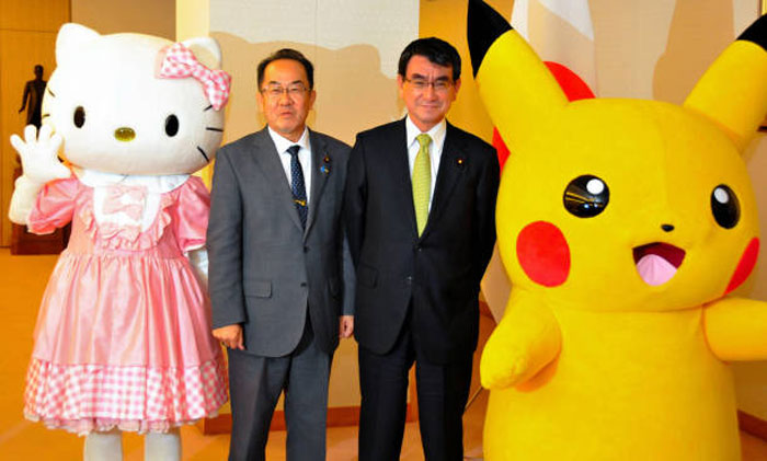 World leaders posing with large Hello Kitty and Pikachu mascots