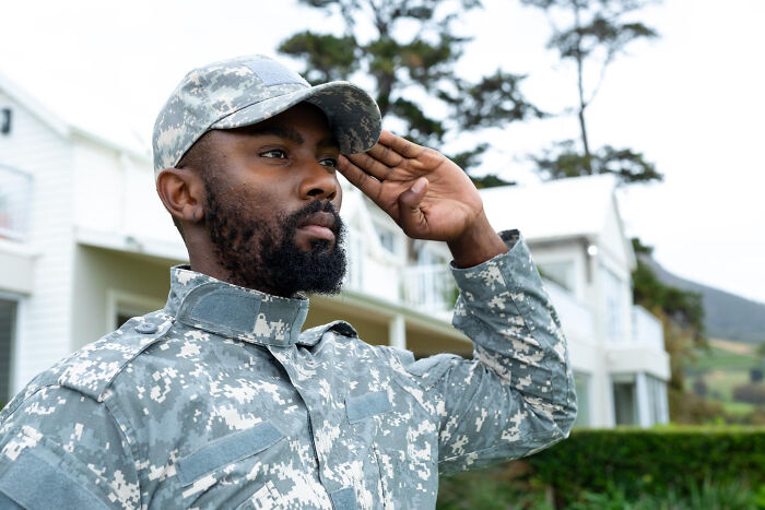 Soldier saluting in uniform with house background unsettling thing found about friend