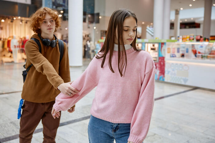 Young couple in mall showing tension of unhinged breakup excuses