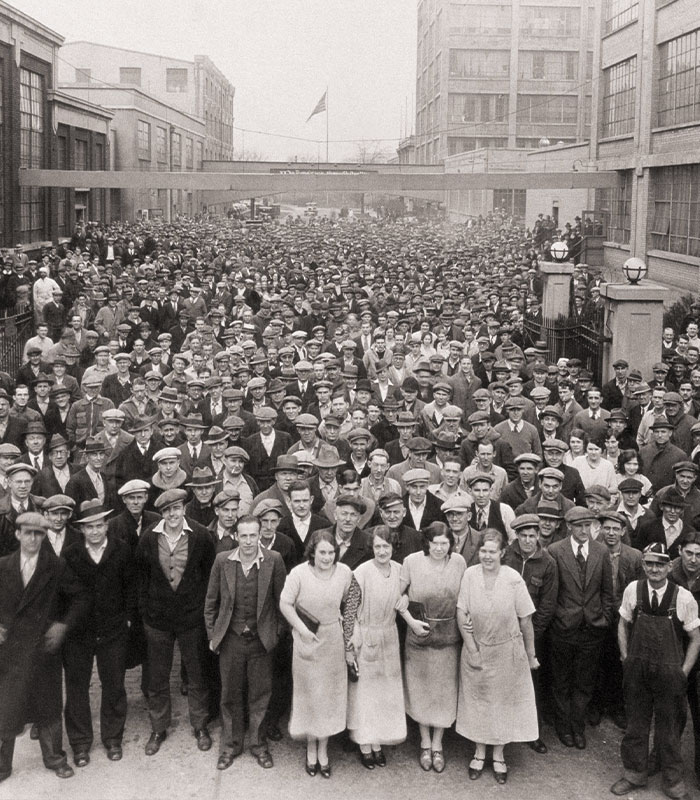 Vintage black and white photo of large crowd of men and women in early 20th century clothing Vintage black and white photo of large crowd of men and women in early 20th century clothing
