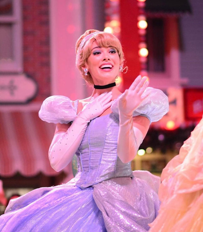 Disney princess Cinderella in light blue gown waving during parade Disney princess Cinderella in light blue gown waving during parade
