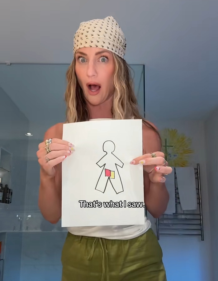 Woman shows drawing explaining airport security scanner flag