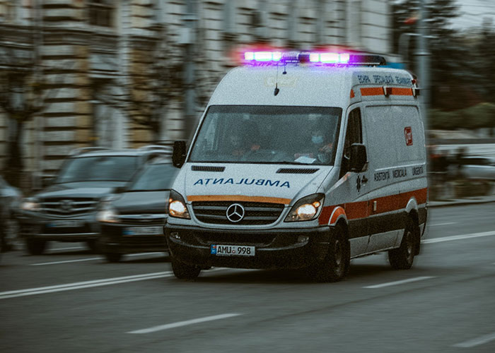 Ambulance rushing on city street representing life emergencies