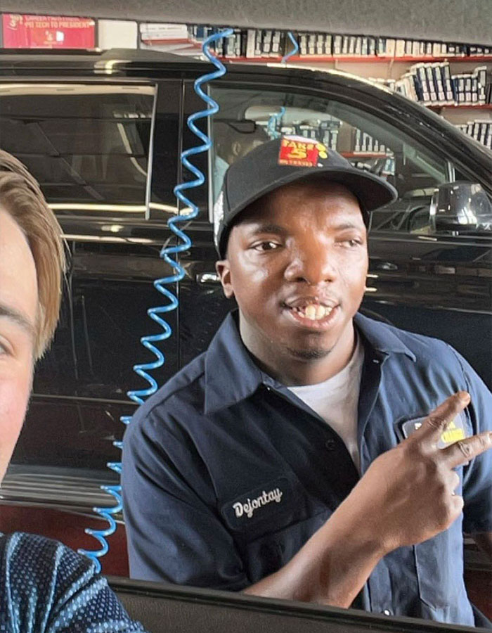 Baton Rouge influencer at Take 5 auto service posing with peace sign Baton Rouge influencer at Take 5 auto service posing with peace sign