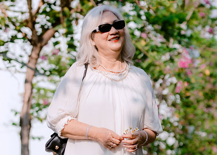 Smiling older woman outdoor, possible mother-in-law at wedding event