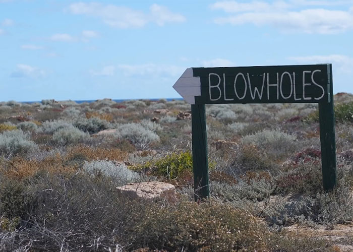 Sign pointing to blowholes in camping area near search for missing girl Sign pointing to blowholes in camping area near search for missing girl