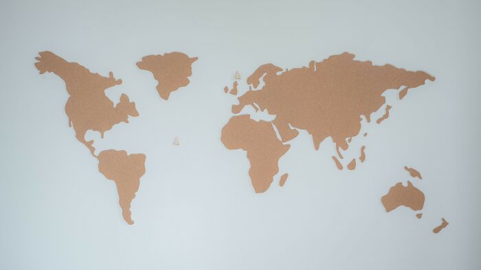 Corkboard world map representing global perspectives on moral dilemmas