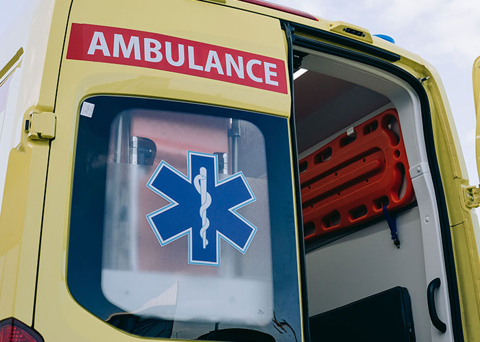The rear of an ambulance with its door open, hinting at the potential downfall for popular kids who peaked in high school.