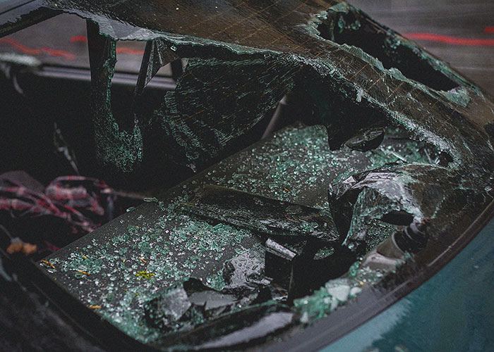 Shattered car windshield with broken glass moment to leave immediately