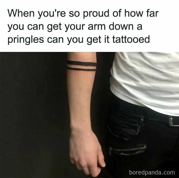 Humorous tattoo meme showing an arm with two simple band tattoos and a caption about getting an arm tattooed to reach the bottom of a Pringles can.