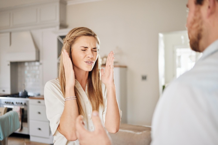 A woman, the fiancée, looks frustrated while talking to a man, suggesting she is the problem in their relationship. A woman, the fiancée, looks frustrated while talking to a man, suggesting she is the problem in their relationship.